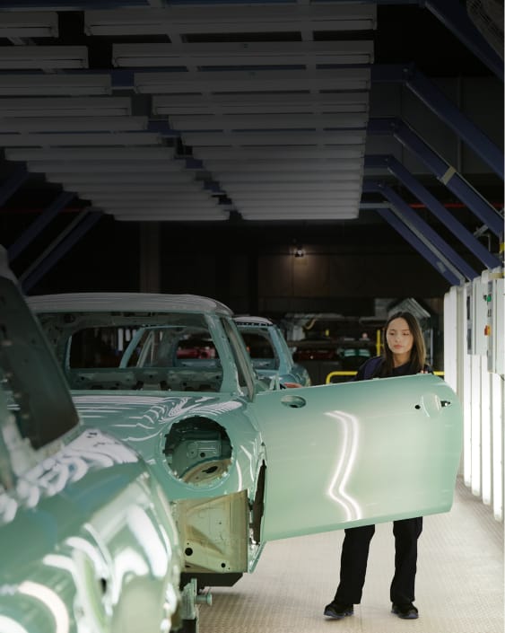 A team member of the Oxford Factory smiling into the distance.