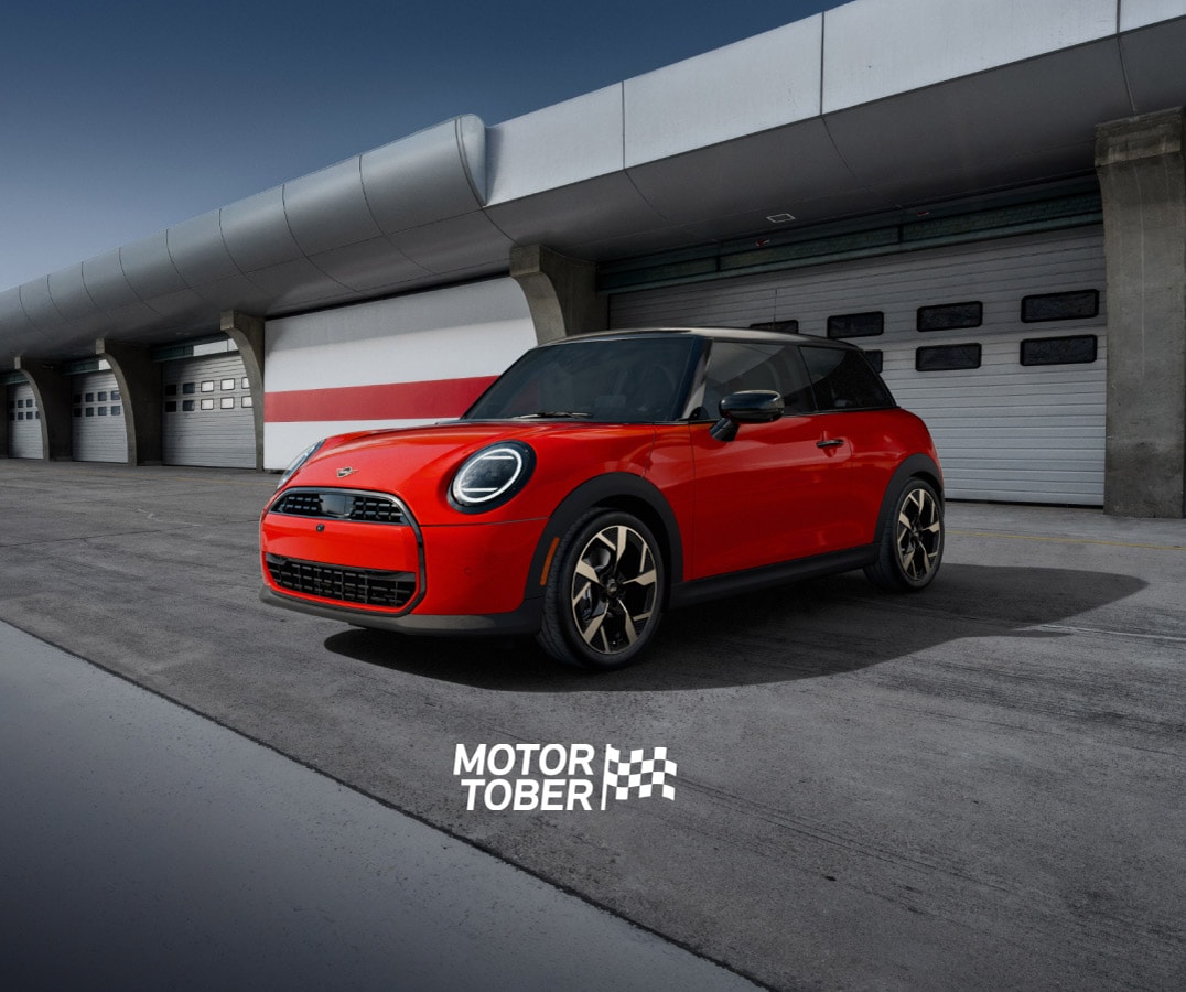 The MINI Cooper C 2 Door parked on a racetrack with a dramatic vignette.