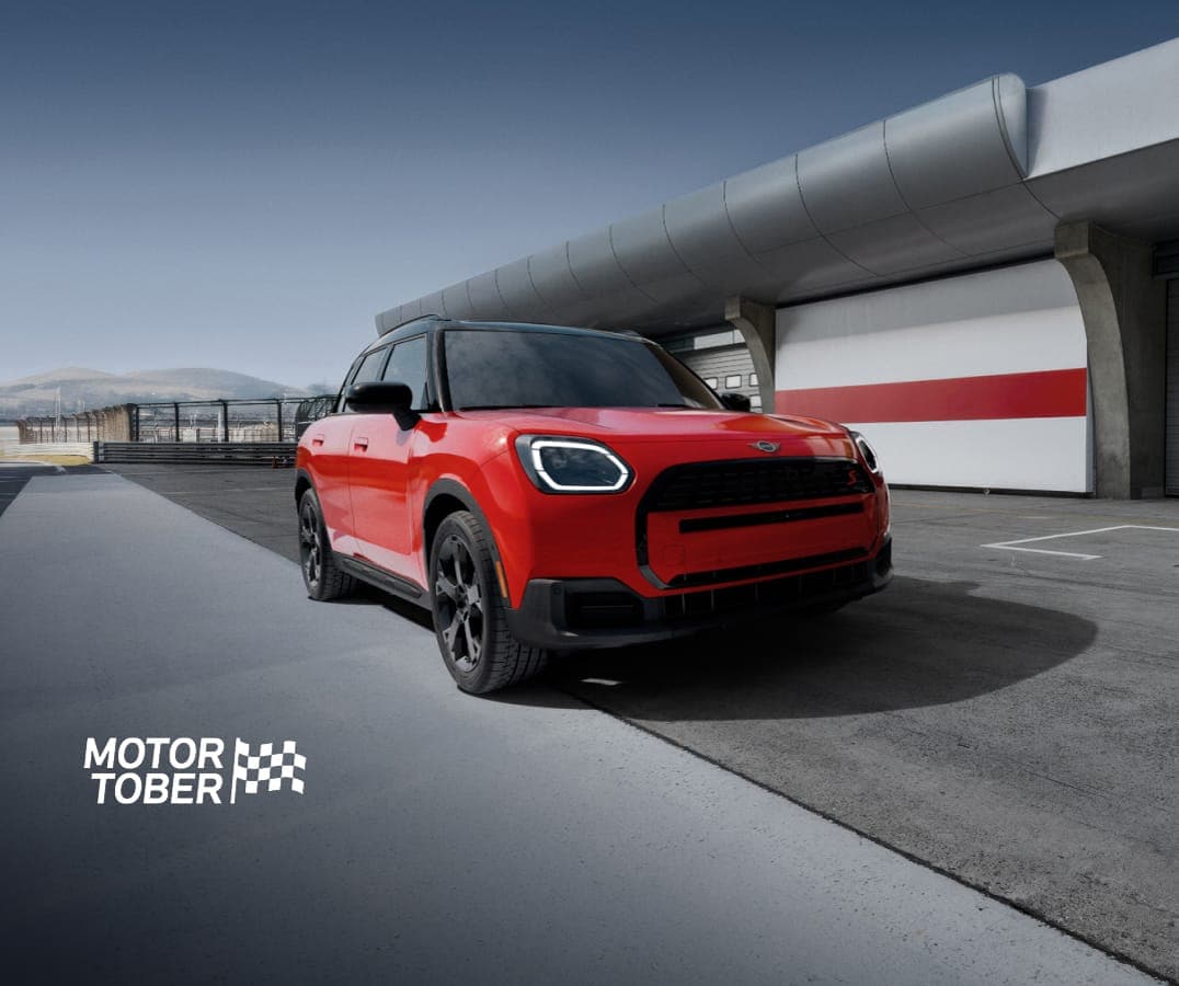 The MINI Countryman S ALL4 parked on an empty racetrack with a dramatic vignette.