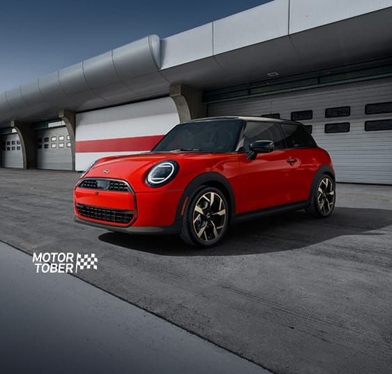 The MINI Cooper C 2 Door parked on a racetrack with a dramatic vignette.
