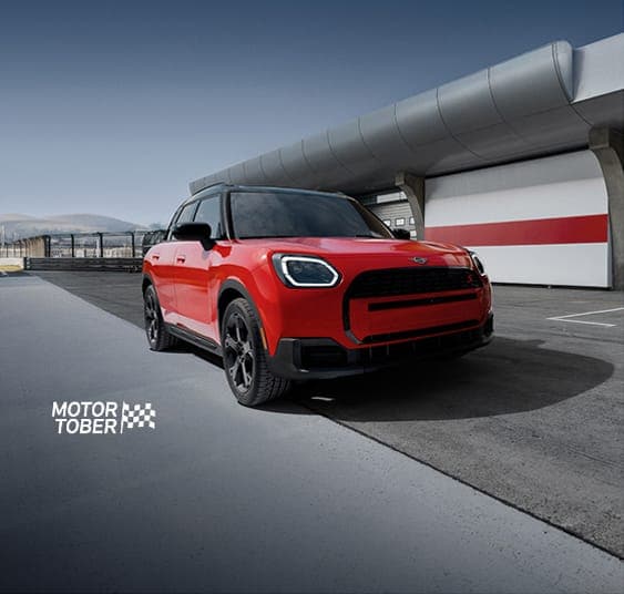 The MINI Countryman S ALL4 parked on an empty racetrack with a dramatic vignette.