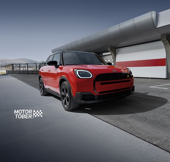 The MINI Countryman S ALL4 parked on an empty racetrack with a dramatic vignette.