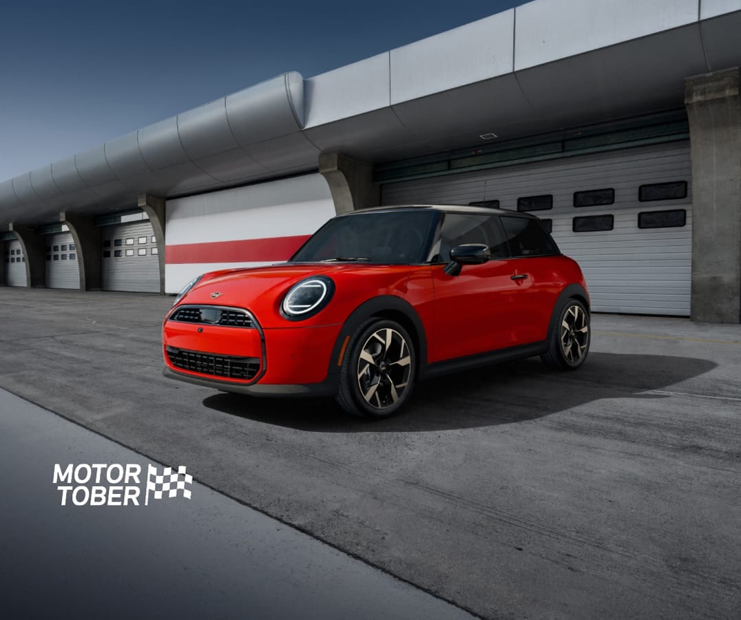The MINI Cooper C 2 Door parked on a racetrack with a dramatic vignette.