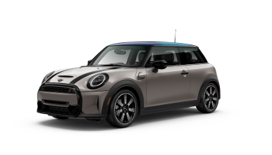 Three-quarters front view of a charcoal MINI Hardtop 2 Door parked on a blank surface with its shadow underneath and nothing surrounding it.