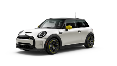 Three-quarters front view of a white MINI Electric Hardtop parked on a blank surface with its shadow underneath and nothing surrounding it.
