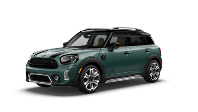 Three-quarters front view of a green MINI Countryman parked on a blank surface with its shadow underneath and nothing surrounding it.