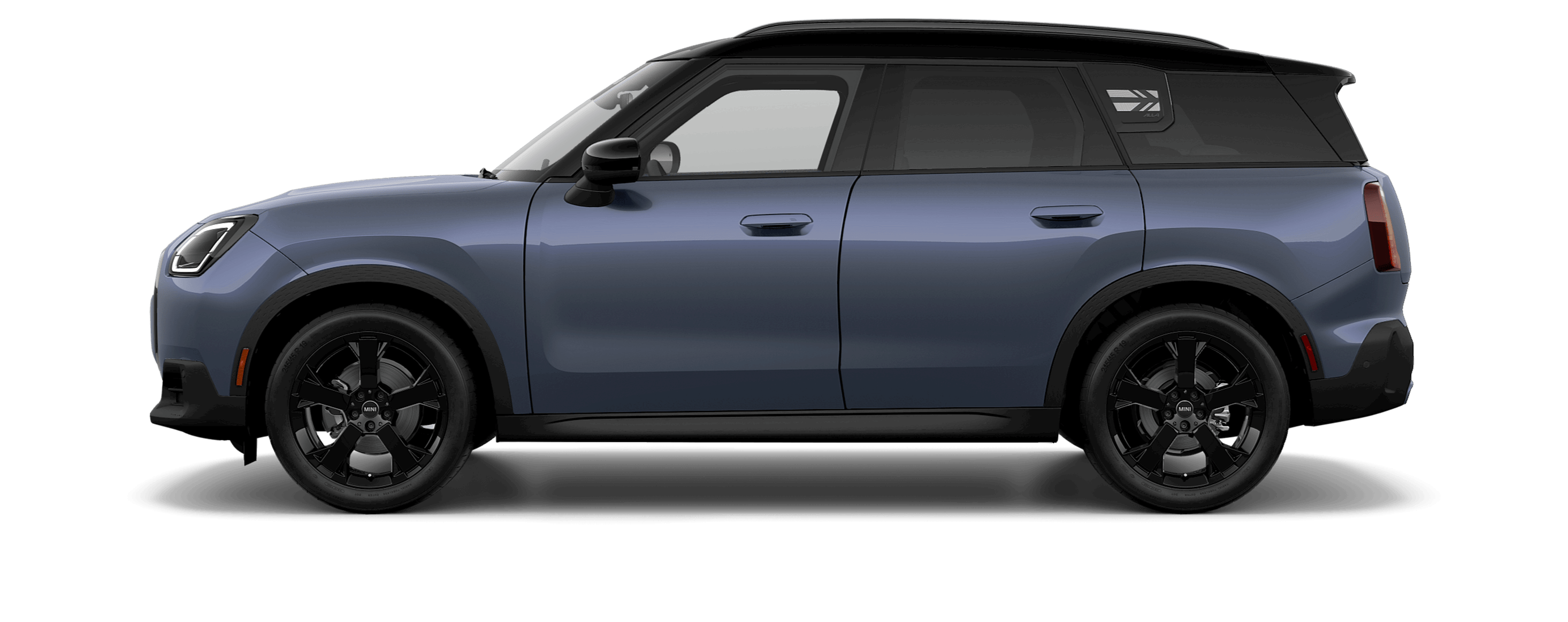 Side view of a MINI Countryman S ALL4 in the Smokey Green body color, facing  left with its shadow underneath it.